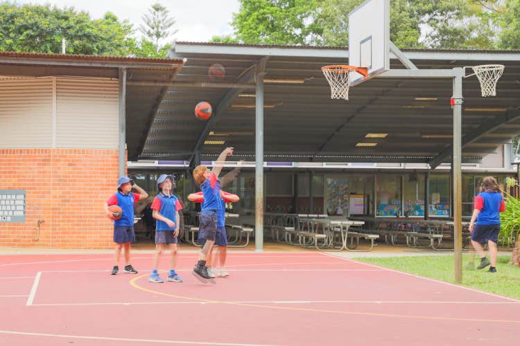 students playing basketball on court